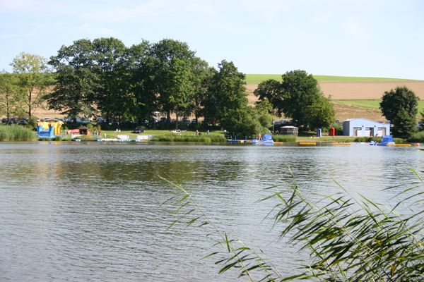 Blick auf Bootssteg und Kiesstrand