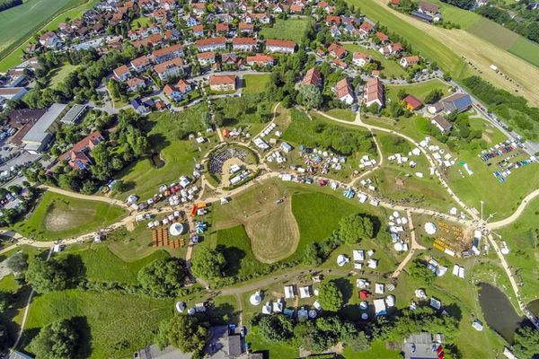 Luftaufnahme des Europaparks in Bogen. In der Mitte die Natur-Freilichtbühne zwischen den verschiedenen Stationen. Rechts im Vordergrund ein Gewässer. Im Hintergrund ein Stadtteil von Bogen.