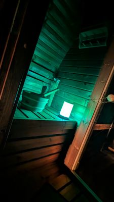 Auf dem Bild ist der Innenbereich der Fass-Sauna bei Dunkelheit zu sehen.