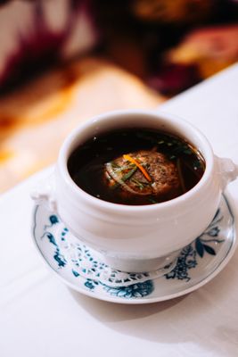 Auf dem Bild ist eine Suppenschüssel mit einem Leberknödel und der Suppe zu sehen.