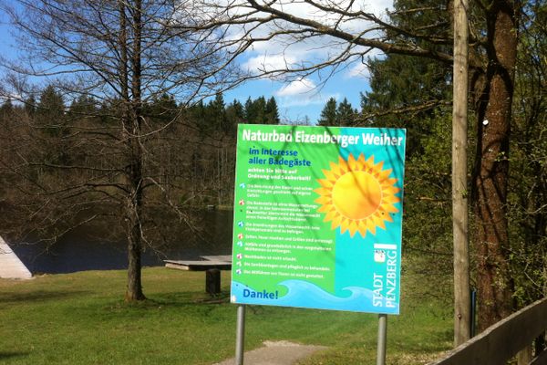 Informationstafel am Seeufer für Badebesucher.
