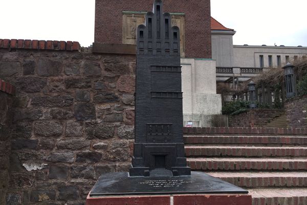 Bronzemodell des Hochzeitsturm zum Ertasten der Form, Fensterbänder und Verzierungen des Turms. Das Modell steht auf einem kleinen Sockel, vor der Treppe die aus dem Platanenhain zum Hochzeitsturm führt.